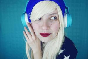 Beautiful blonde woman listening to music photo