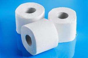 Rolls of toilet paper on a blue background photo