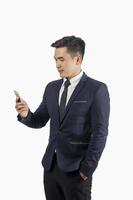Handsome businessman using smart phone isolate on white background photo