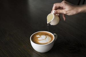 Hot latte art on wood table photo