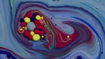 Abstract close up texture of oil with blue, red and yellow paint video