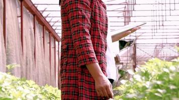 A young female farmers with a tablet in her hand working video