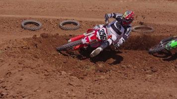 Motocross racers going over big jump in slow motion 4K fully released video