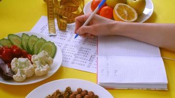 A Food Journal Being Filled out While Snacking