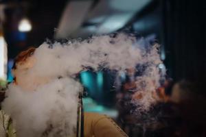 Man in restaurant smoking hookah. photo