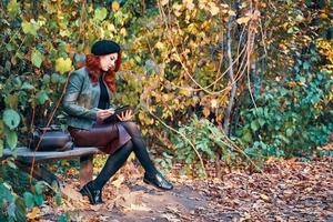 Autumn portrait of a red-haired woman. photo