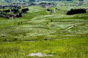 Grassy hills and town photo