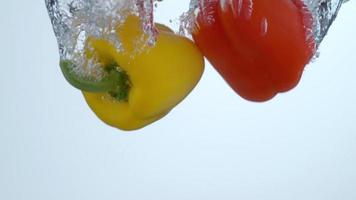 Bell peppers splashing into water in slow motion shot on Phantom Flex 4K at 1000 fps video