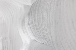 White embossed walls of ice and snow in a cave. Abstract textured natural background. photo