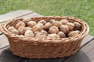 Walnut bunch in wooden basket photo