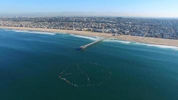 Aerial shot of surfers paddling out for protest on the ocean. video