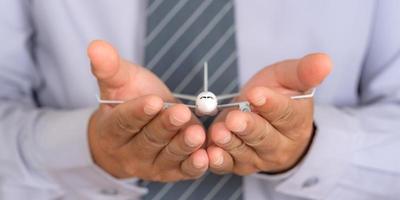 Insurance travel concept, Airplane model on Support hands, Protection plane safe protect photo
