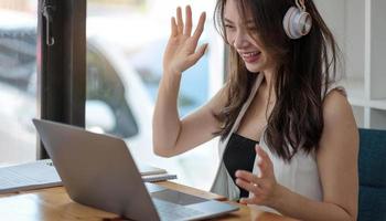 Smiling businesswoman looking at camera webcam conference business group call, online training concept photo