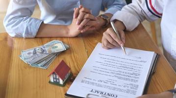 Experienced real estate agent showing house model to client and ready to sign a contract photo