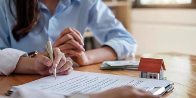 Experienced real estate agent showing house model to client and ready to sign a contract photo