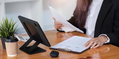 Business advisor showing plan of investment to clients in the consultancy office photo