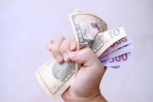 Hand holding dollar banknotes photo