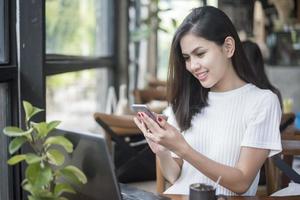 Beautiful business girl working with tablet , smartphone and drinking coffee in coffee shop photo