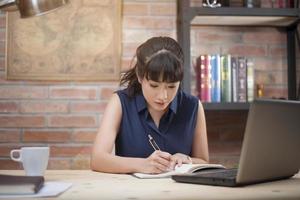 Beautiful woman is working in home office photo