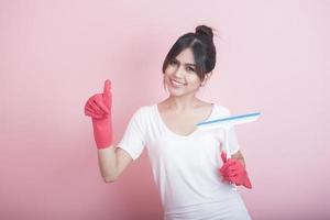 Beautiful asian housewife smiling on pink background photo