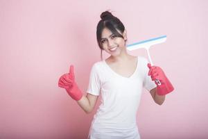 Beautiful asian housewife smiling on pink background photo