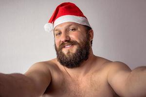 Bearded half-naked Santa Claus man photo
