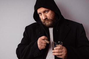 Handsome elegant bearded man wearing black coat with hood photo