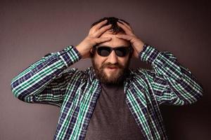 Handsome hipster bearded man with sunglasses and shirt photo