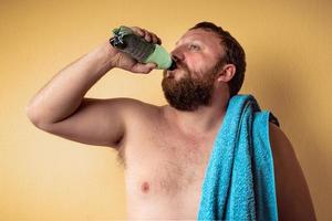 Hombre barbudo semidesnudo cansado y agotado después del entrenamiento foto