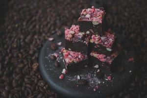 Homemade chocolate fudge with strawberries and pine nuts photo