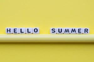 Hello summer word cubes, on a yellow background. photo