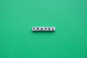 Ttravel word on a green background. Summer and travel concept photo