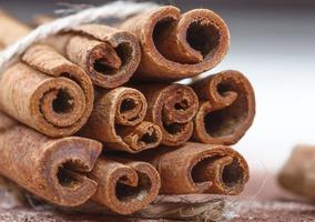 Cinnamon sticks and cocoa powder accessories for a cozy winter evening near the fireplace with a glass of wine photo
