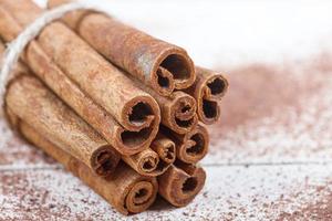 Cinnamon sticks and cocoa powder accessories for a cozy winter evening near the fireplace with a glass of wine photo