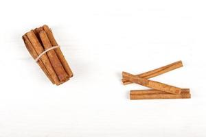 Cinnamon sticks and cocoa powder accessories for a cozy winter evening near the fireplace with a glass of wine photo