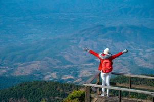 Young people walking on a hilltop in Doi Inthanon, Chiang Mai, Thailand photo