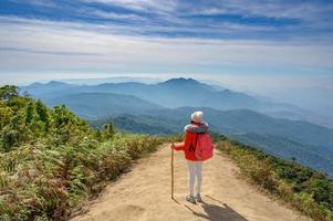 Young people walking on a hilltop in Doi Inthanon, Chiang Mai, Thailand photo