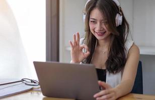 Smiling businesswoman looking at camera webcam conference business group call, online training concept photo