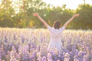 Freedom And Healthy a girl stretching her arms in the sun among the butterflies photo