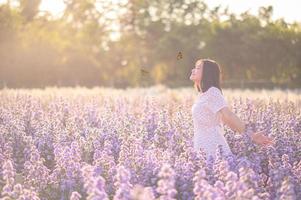 Freedom And Healthy a girl stretching her arms in the sun among the butterflies photo