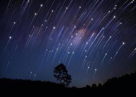 Rotating star galaxy mountain night blue sky photo