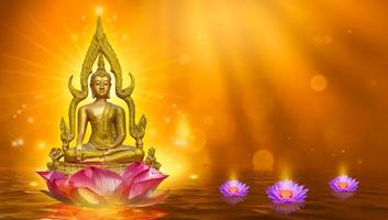 Buddha statue water lotus Buddha standing on lotus flower on orange background photo