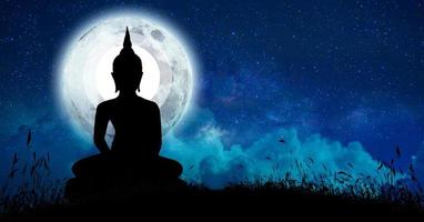 The Buddha meditated among many stars and a large moon. photo
