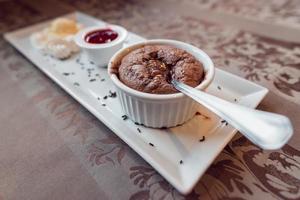 Chocolate souffle with icecream and forest fruit dressing. Concept, restaurant menus, healthy eating, homemade. photo