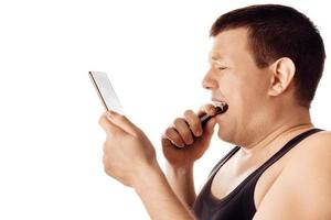 Desperate stressed worried young man reading some bad news from his tablet. Human emotion, reaction, expression. Isolated on white background. photo