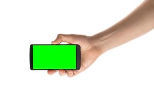 Male hand holds black smartphone. Isolated screen with chroma key and all isolated on white background. photo