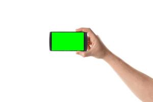 Male hand holds black smartphone. Isolated screen with chroma key and all isolated on white background. photo