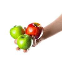 Man holding bunch of red and green apples in his hand. Isolated on white background. photo