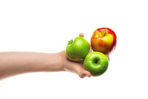 Man holding bunch of red and green apples in his hand. Isolated on white background. photo