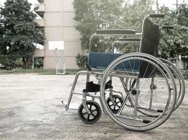 Empty wheelchair parked in the park. photo